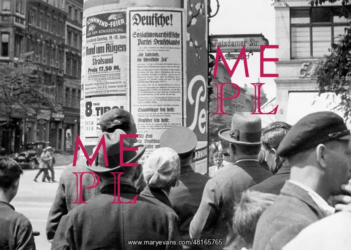 : Pedestrians while looking at an election poster : Pedestrians while looking at an election poster
