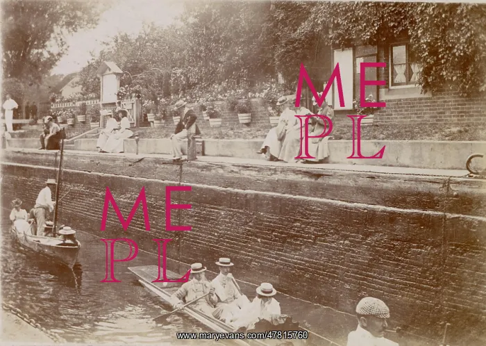 : People boating on a canal, with spectators above them : People boating on a canal, with spectators above them