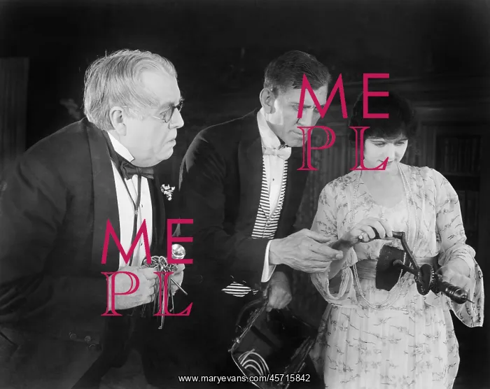 : Three people checking out a manual drill : Three people checking out a manual drill