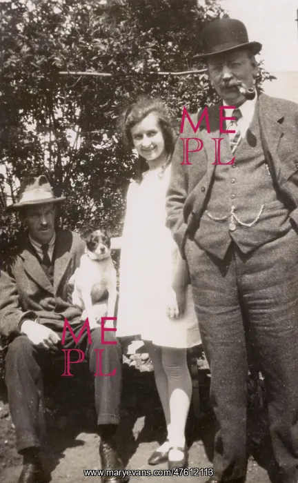  : Three people and a dog in a garden