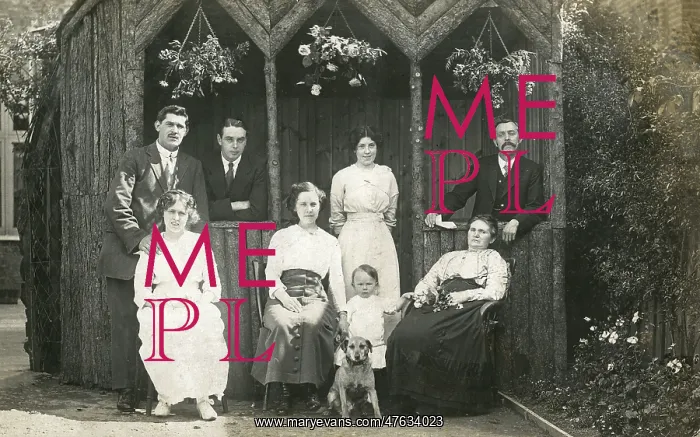  : Eight people with a dog in a garden