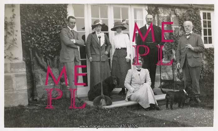  : Six people with two dogs in a garden