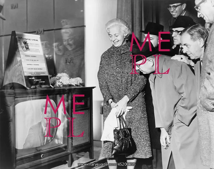 : People gather around a television outside ? : People gather around a television outside ?