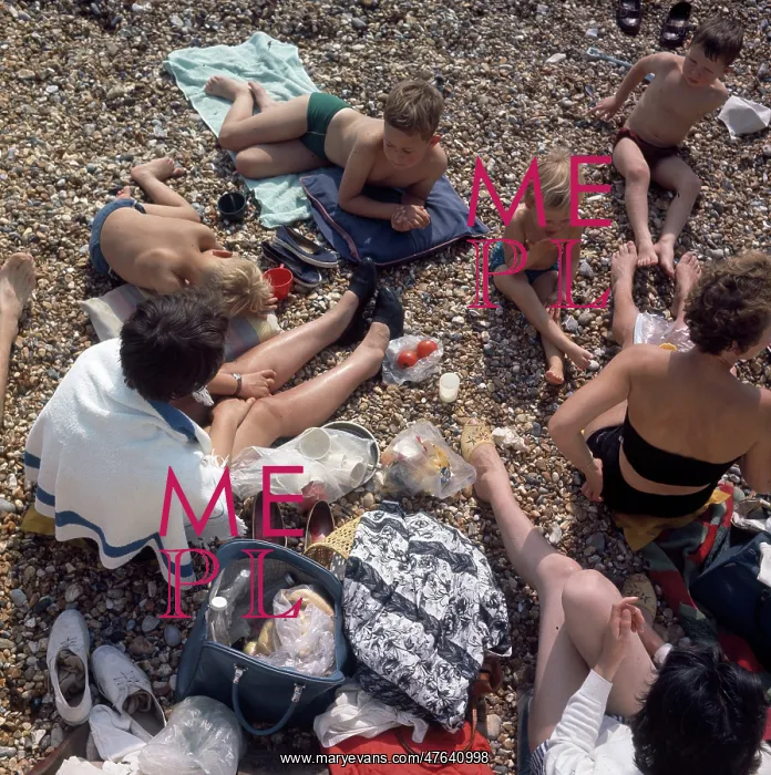 : People having a picnic on a pebbly beach : People having a picnic on a pebbly beach