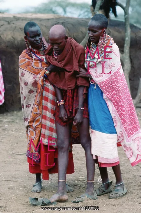: People of Kenya. A maasai lady being assisted : People of Kenya. A maasai lady being assisted