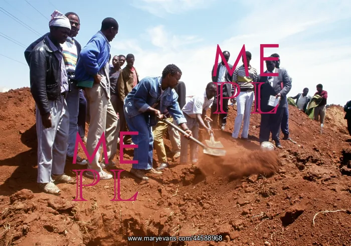 : People look on as the grave is filled with soil : People look on as the grave is filled with soil