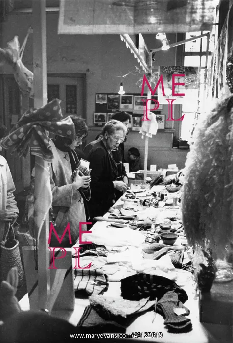 : People looking at items on a fundraising stall : People looking at items on a fundraising stall
