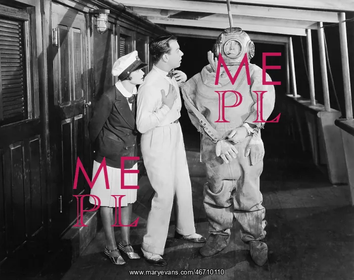 : Two people looking in shock at a diver in a divers suit : Two people looking in shock at a diver in a divers suit