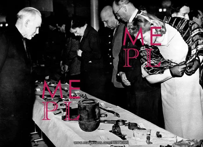 : People looking at torture instruments by which : People looking at torture instruments by which