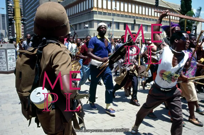 : People, mainly men, armed with traditional weapons : People, mainly men, armed with traditional weapons