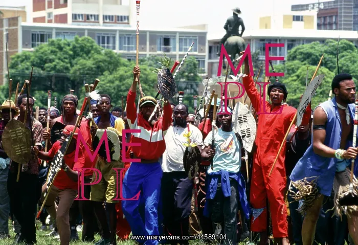 : People, mainly men, armed with traditional weapons : People, mainly men, armed with traditional weapons