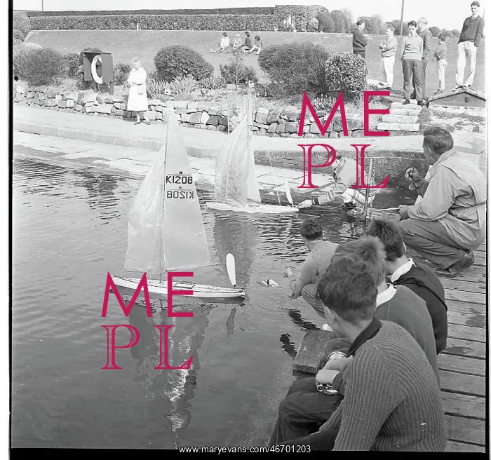  : People with model sailing boats on a pond