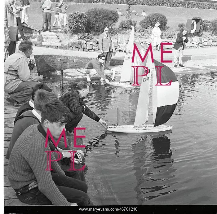  : People with model sailing boats on a pond