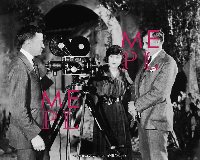 : Three people with movie camera : Three people with movie camera