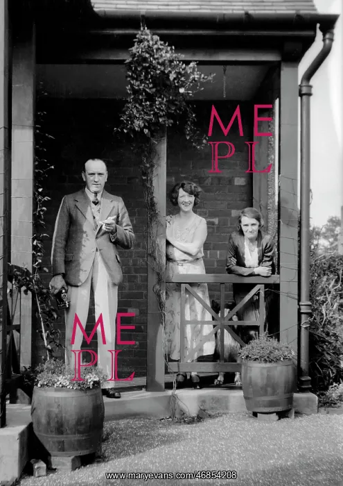: Three people outside a house : Three people outside a house