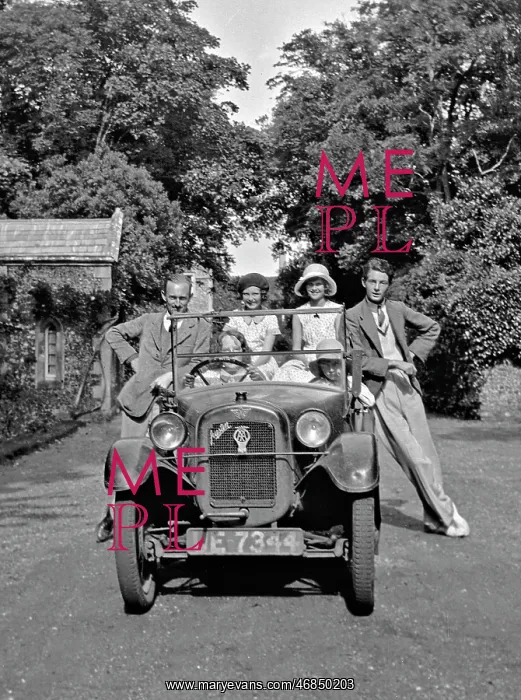 : People posing with Austin car : People posing with Austin car