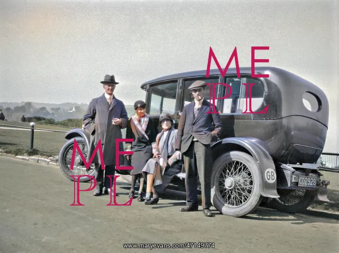  : Four people relaxing by their car at the roadside