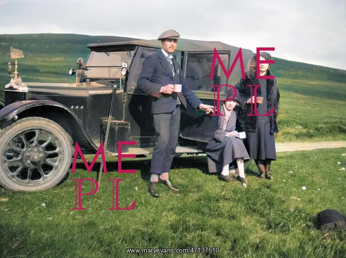  : Three people resting at the side of their car