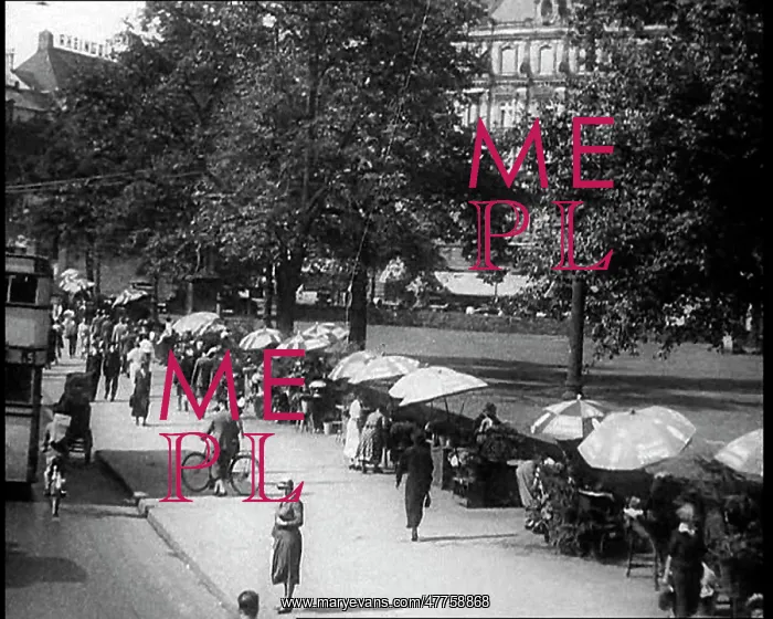 : People Sitting Under Parasols and Walking Down : People Sitting Under Parasols and Walking Down