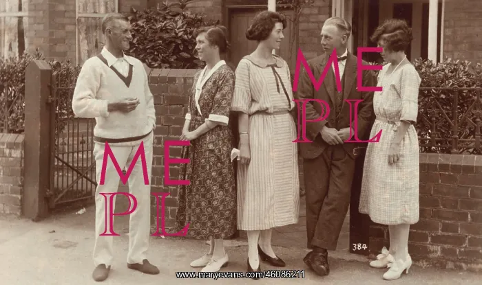 : Five people standing outside a house : Five people standing outside a house