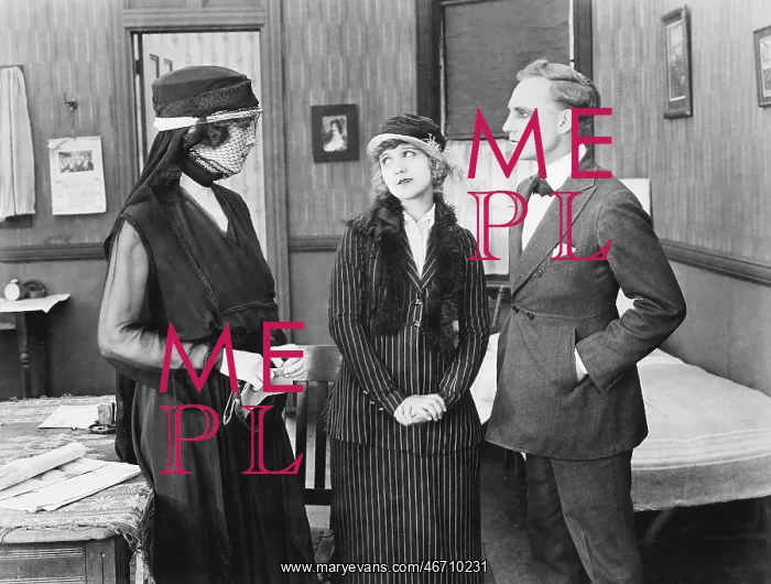 : Three people standing together in a room talking : Three people standing together in a room talking