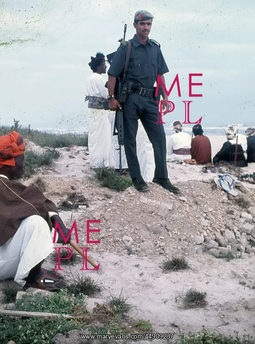 : People standing and sitting on the beach in Oman : People standing and sitting on the beach in Oman