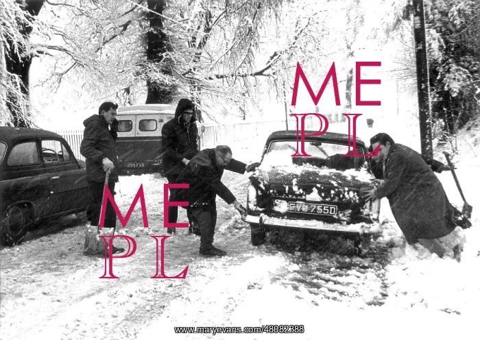 : People trying to move a snowbound car : People trying to move a snowbound car