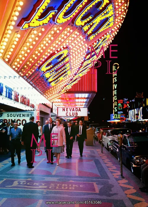 : People Walking on Sidewalk Beneath Large Neon : People Walking on Sidewalk Beneath Large Neon