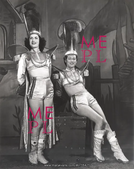: Two performers dressed in magician assistant costumes : Two performers dressed in magician assistant costumes