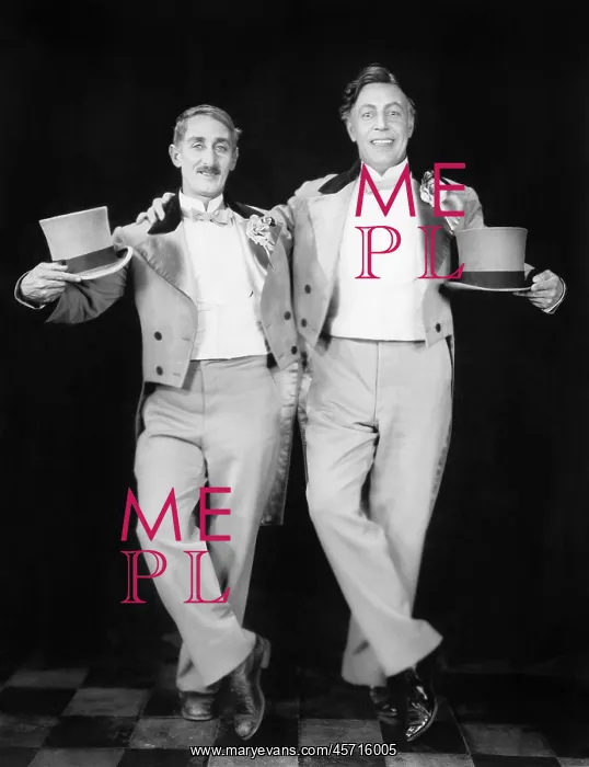 : Two performers posing after a dance : Two performers posing after a dance