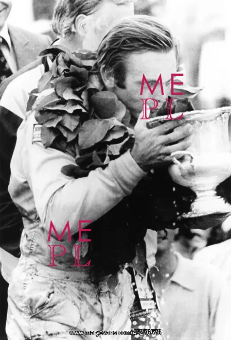 : Peter Revson drinks from his trophy after winning : Peter Revson drinks from his trophy after winning