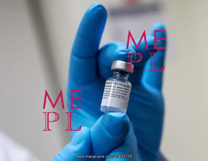 : Pfizer-BioNTech COVID-19 vaccine vial is held : Pfizer-BioNTech COVID-19 vaccine vial is held