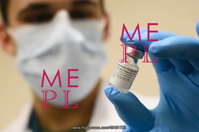 : Pfizer-BioNTech COVID-19 vaccine vial is held : Pfizer-BioNTech COVID-19 vaccine vial is held