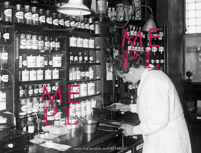 : Pharmacist while preparing medications : Pharmacist while preparing medications