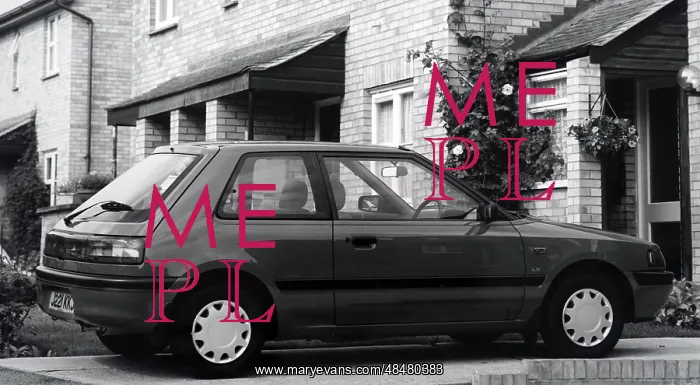 : A photograph of a Mazda 323 : A photograph of a Mazda 323