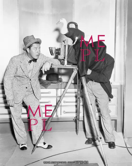 : Photographer taking a picture of a young man : Photographer taking a picture of a young man