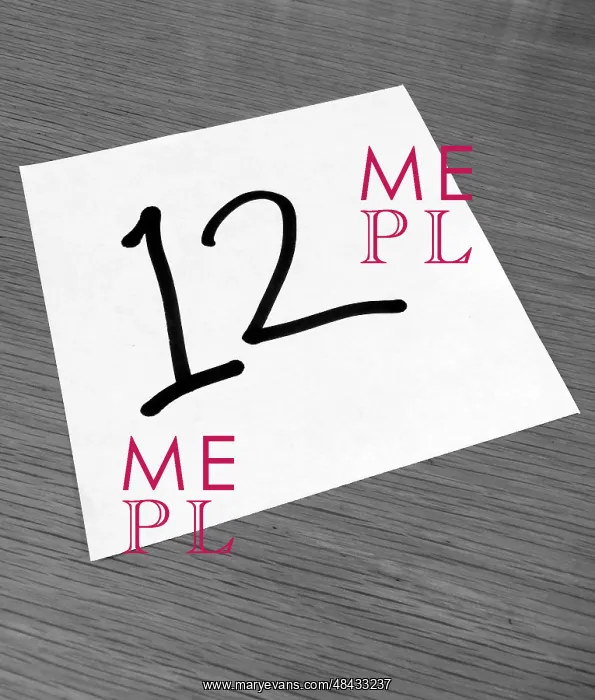 : Piece of paper on a desk with a large number 12 : Piece of paper on a desk with a large number 12