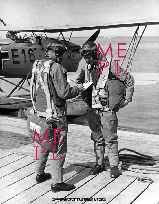: Pilot and navigator studying a map, 1937 : Pilot and navigator studying a map, 1937