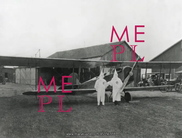 : Two pilots in Ku Klux Klan shrouds pose with their : Two pilots in Ku Klux Klan shrouds pose with their