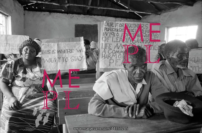 : Placards at meeting to protest their possible forced : Placards at meeting to protest their possible forced