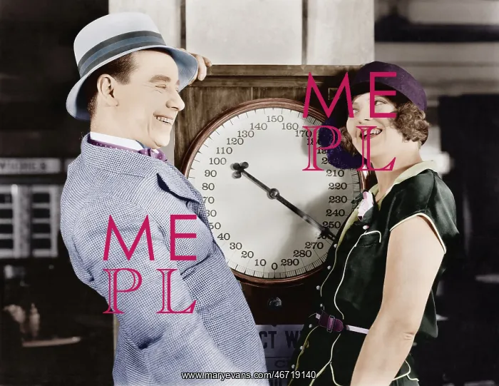 : Playful couple standing on scale : Playful couple standing on scale