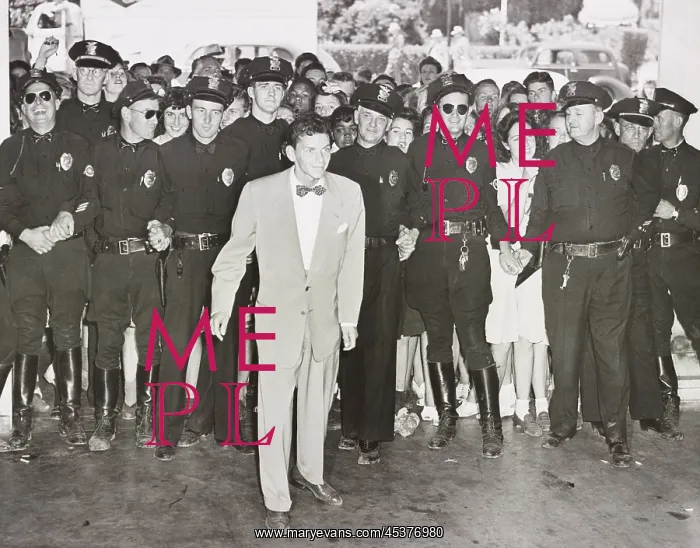: A police line protects Frank Sinatra from : A police line protects Frank Sinatra from