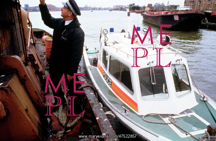 : Policeman investigating a river barge : Policeman investigating a river barge