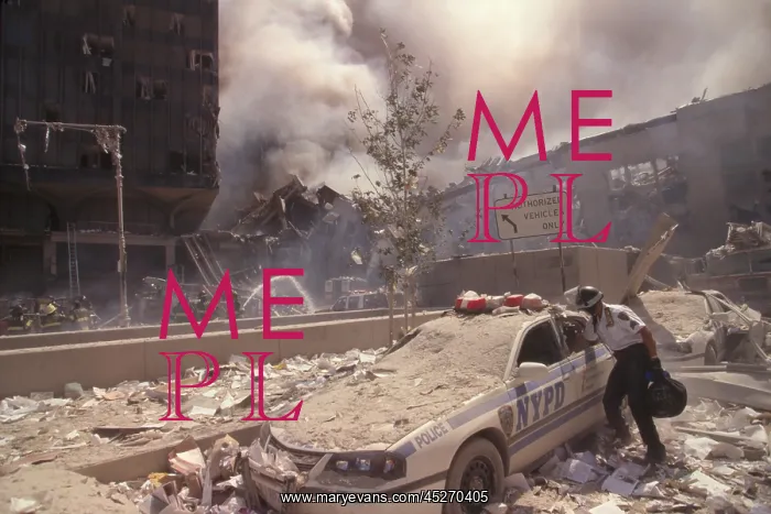 : Policeman reaching into a debris covered police : Policeman reaching into a debris covered police