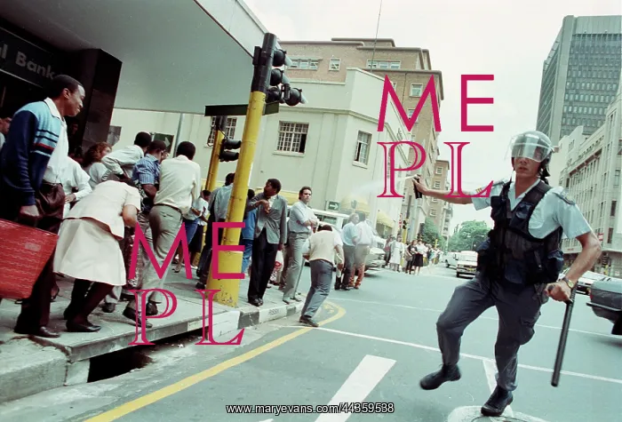 : Policeman teargases a crowd : Policeman teargases a crowd