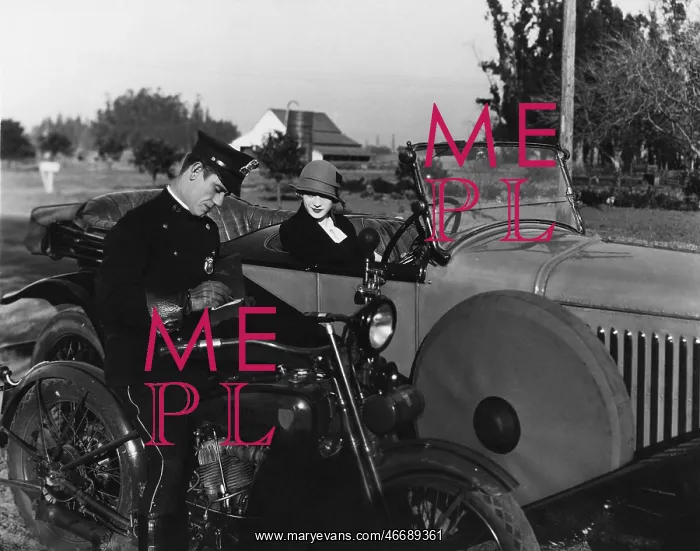 : Policeman writing female driver ticket : Policeman writing female driver ticket