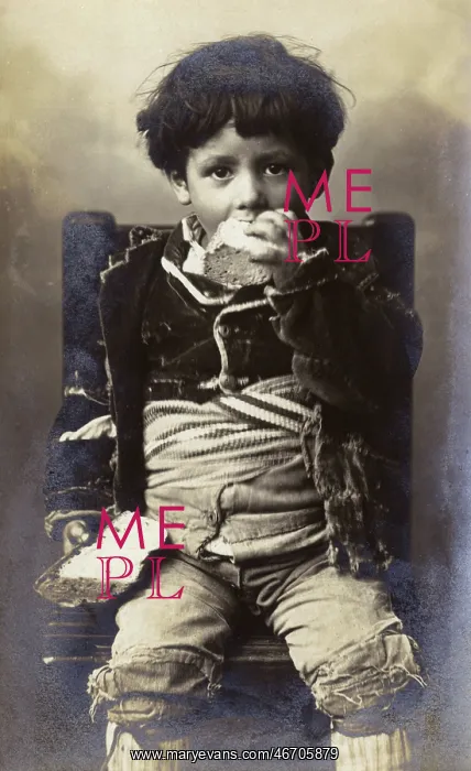  : A poor young boy tucking into a hunk of bread - Italy
