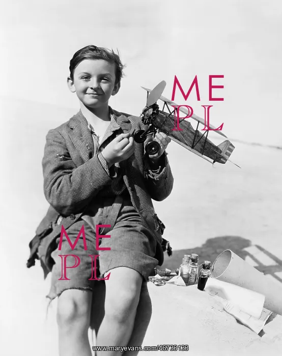: Portrait of a boy holding a model airplane and smiling : Portrait of a boy holding a model airplane and smiling