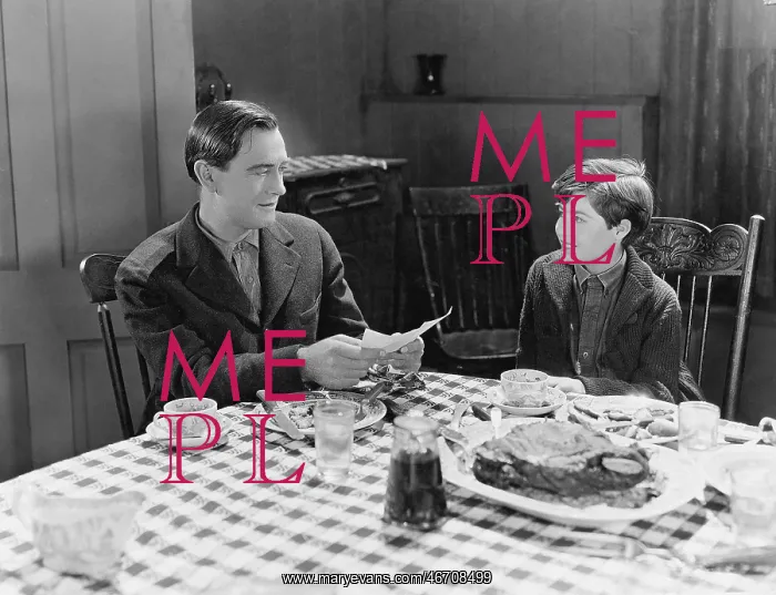 : Portrait of father and son at dinner table : Portrait of father and son at dinner table