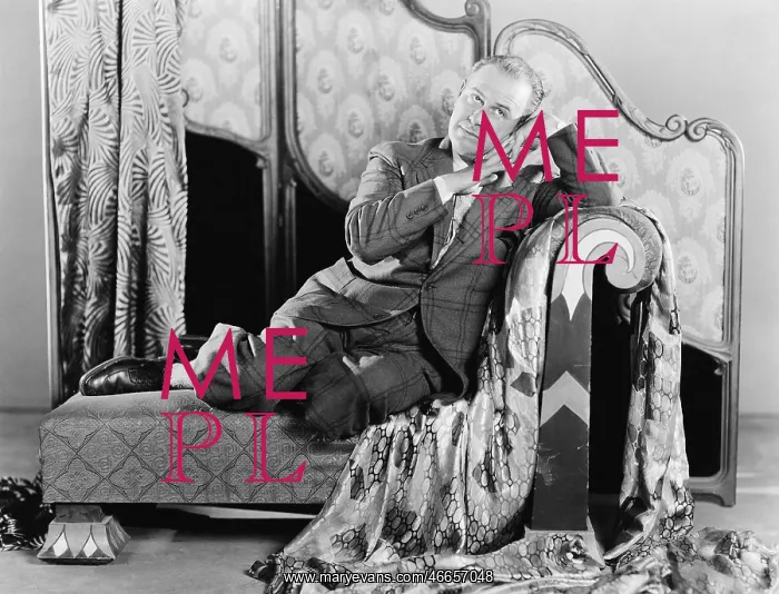 : Portrait of a man sitting on a couch : Portrait of a man sitting on a couch
